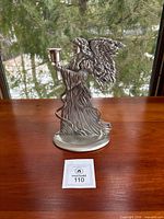 Full view of pewter angel figurine holding candle cup