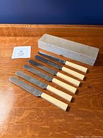 Full set of six knives with box displayed on wooden surface