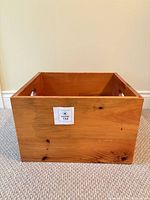 Front view of pine storage box showing natural finish and MaxSold label