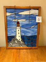 Full view of stained glass panel in frame on table