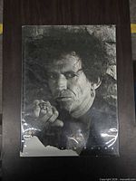 Front cover showing black and white portrait and overall book condition