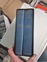 Spine view of both volumes in slipcase showing titles and publisher