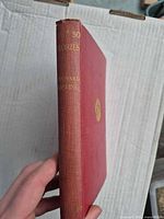 Spine view showing gilt title, author name, cloth fade, corner wear