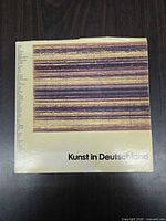 Front cover of the art book showing title and abstract stripe artwork