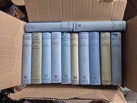 All 12 Buchan hardcovers in box, spines visible