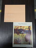 Front covers of both softcover art books Carol Wainio and Tom Thomson