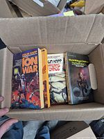 Top view of box showing three paperbacks: The Ion War, Patterns of Chaos, World Without Children / The Earth Quarter