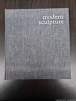 Front cover showing gray linen cloth and title modern sculpture