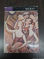 Front of dust-jacket showing Seurat artwork and title