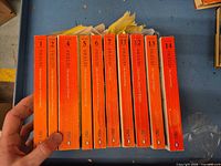 Spine view of fourteen sequentially numbered orange Penguin Freud Library paperbacks
