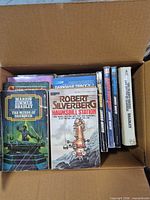 Open box showing The Winds of Darkover, Hawksbill Station and a row of upright spines