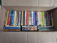 Box of mass market paperbacks stacked spine up
