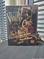 Front cover of Violent Cases 30th Anniversary hardcover with dust jacket