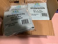 Box containing multiple sealed Secure underpad packs