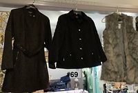 All three outerwear items hung for overview: two black jackets and grey faux fur vest