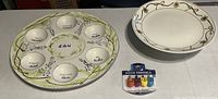 Front view of seder plate, decorative plate and packaged dreidels