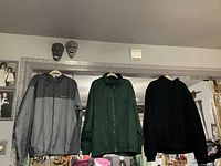 Front view of all three jackets on hangers
