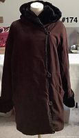 Front view of brown hooded coat on mannequin