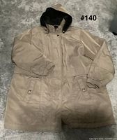 Front view of brown hooded coat showing overall style and pockets