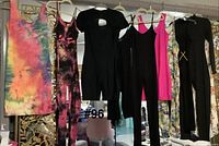 Group shot of hanging dress and jumpers/rompers