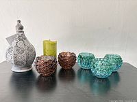 All seven items: metal lantern, LED candle, two amber votives, three aqua votives