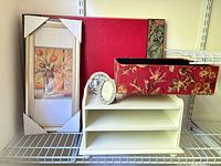 Group shot of all items: fabric box, desk organizer, blotter, framed art, two photo frames