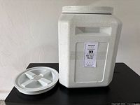 Front view of canister with lid beside it
