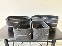 Front view of all four gray felt bins, showing two sizes