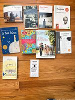 All nine French paperback books laid out on floor