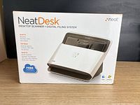 Front of NeatDesk retail box showing product image and branding