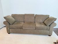 Front view of 3-seater fabric sofa with cushions