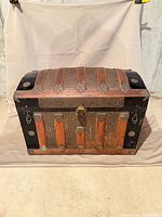 Front view showing dome lid, wood slats, metal panels, latch