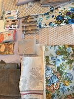 Overview of assorted fabrics, sewing patterns, booklets