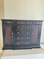 Front view of black sideboard with drawers and cabinets closed