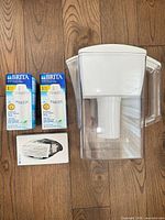 pitcher, two filter boxes, indicator box on wood floor