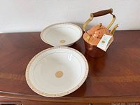 Full lot showing two porcelain bowls and copper teapot