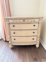 Front view showing full dresser, drawer arrangement and decorative details