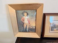 Portrait print of boy in gold-tone frame