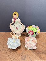 Group shot of three figurines and floral posy