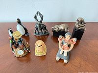 All eight figurines displayed on table