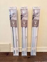 Front view of three boxed Modern Homes sheer shades