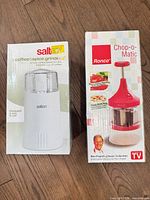 Front view of boxed Salton grinder and boxed Ronco chopper
