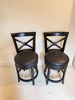 Front view of both black swivel counter stools