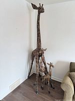 All three giraffe sculptures in corner for scale