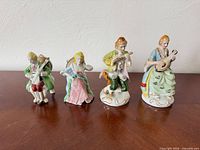 Front view of all four porcelain musician figurines