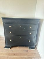 Front view of black Stanley filing chest showing drawers and knobs