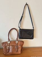 Front view of both handbags showing size, color and style