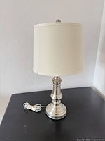 Full view of lamp front showing base, column, shade, cord