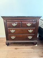 Front view showing full dresser, drawer configuration, hardware and carved details