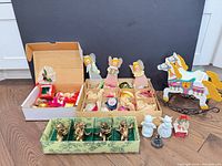 Full lot overview showing boxed glass ornaments, angel figures, cherub box, wooden rocking horse, assorted small ornaments and figurines